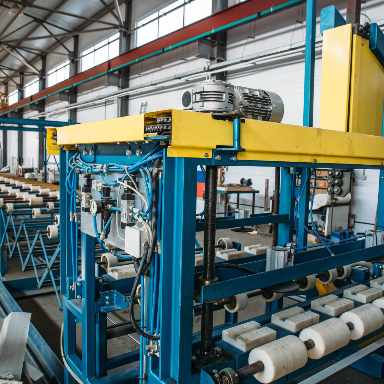 Industrial manufactory workshop for thermal insulation sandwich panel production line for construction. Modern manufacturing storage with machine tools, roller conveyor, factory interior inside
